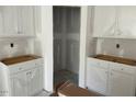 Unfinished kitchen featuring white cabinets and drywall, showcasing a spacious layout awaiting final touches at 277 Gregory Village Dr, Lillington, NC 27546