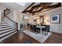Elegant dining room with decorative ceiling beams, modern chandelier, and open floor plan at 292 Choice Trl, Pittsboro, NC 27312