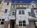 Exterior elevation features new townhome with siding and brick, currently undergoing final construction and finishing touches at 328 Chesapeak Commons St # 142, Garner, NC 27529