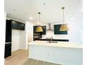 A modern kitchen with a large island and gold pendant lights at 3291 Roundly Rd # 14, New Hill, NC 27562
