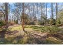 Spacious backyard features beautiful trees and landscaping at 35 Rogerson Dr, Chapel Hill, NC 27517