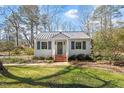 Charming single story home with metal roof and brick steps leading to the front door at 35 Rogerson Dr, Chapel Hill, NC 27517