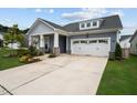 Well-maintained home with a two-car garage, a landscaped front yard, and a covered front porch at 3528 Olive Glen Dr, Apex, NC 27502
