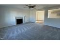 Spacious living room with a fireplace, neutral walls, and plush gray carpeting at 38 Flatland Dr, Princeton, NC 27569