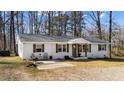 Ranch-style home with a brick facade, decorative shutters and welcoming front patio at 4775 Barber Mill Rd, Clayton, NC 27520