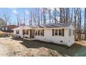 Ranch-style home with a brick facade, decorative shutters and a covered front porch at 4775 Barber Mill Rd, Clayton, NC 27520