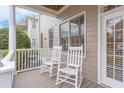 Charming front porch featuring two white rocking chairs and a view of the neighborhood at 604 Copperline Dr # 108, Chapel Hill, NC 27516