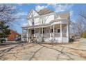 Charming two-story home featuring a classic wrap-around porch and decorative architectural details at 616 N Mebane St, Burlington, NC 27217