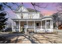 Charming two-story home featuring a classic wrap-around porch and decorative architectural details at 616 N Mebane St, Burlington, NC 27217
