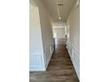 Inviting hallway featuring wood floors, paneled walls, recessed lighting, and access to other rooms at 72 Victory View E Ter, Smithfield, NC 27577