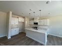 Open concept kitchen with a large island, pendant lights, and stainless steel appliances at 82 Fairwinds Dr, Lillington, NC 27546