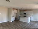 Spacious living room featuring hardwood floors, ample natural light, and an open layout with modern kitchen at 82 Fairwinds Dr, Lillington, NC 27546