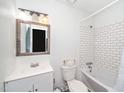 Clean bathroom with a white vanity, subway tile surround bathtub, and modern fixtures at 100 Forsyth Dr, Chapel Hill, NC 27517