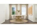 Bright dining area showcasing neutral decor, modern chairs, and wood-look flooring at 10064 Regal Dr, Angier, NC 27501