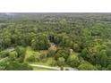 Expansive wooded property with mature trees and manicured grounds at 1017 Holly Creek Ln, Chapel Hill, NC 27516