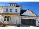 Newly constructed two-story home with a two-car garage and light gray siding at 106 Willow Cameron Way, Angier, NC 27501