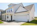 New construction two-story home with attached two car garage and covered entryway at 106 Willow Cameron Way, Angier, NC 27501