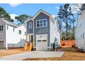 Charming two-story home with a garage and a wooden staircase leading to the front entrance at 1211 Chaney Rd, Raleigh, NC 27606