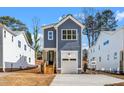 Charming two-story home with a garage and a wooden staircase leading to the front entrance at 1211 Chaney Rd, Raleigh, NC 27606