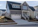 This stunning two-story home features a two-car garage and covered entryway and manicured lawn at 1245 Barreto Dr, Wendell, NC 27591