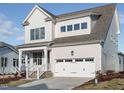 Charming two-story home with a two-car garage, covered porch, and meticulous landscaping at 1245 Barreto Dr, Wendell, NC 27591