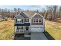 Two-story home with gray and white siding, inviting front porch, and well-manicured lawn at 1318 Reading Ct, Burlington, NC 27217