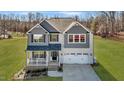 Beautiful home featuring a front porch, a well-manicured lawn and a two-car garage at 1318 Reading Ct, Burlington, NC 27217