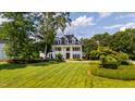 Expansive lawn surrounds this stately brick home with pillared front entry at 1416 Barony Lake Way, Raleigh, NC 27614