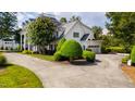 Side view of stately brick home with attached garage and circular driveway at 1416 Barony Lake Way, Raleigh, NC 27614