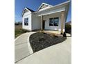 This new build boasts a covered porch, black framed windows, and sidewalk to driveway at 151 E Washington St, Coats, NC 27521