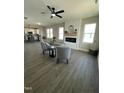 This living room has hardwood floors, a fireplace, a ceiling fan, and views into the kitchen at 151 E Washington St, Coats, NC 27521