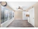 Bright living area with a ceiling fan and large windows showcasing a wooded, private area at 1738 Quail Ridge Rd, Raleigh, NC 27609