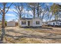 Charming white house with well-kept lawn, side yard, and a detached garage adding extra value at 210 Circle Dr, Smithfield, NC 27577