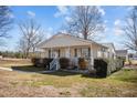 Inviting single-story home with covered porch, trimmed bushes, and easy access walkway at 231 Patterson Dr, Roxboro, NC 27573