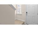 Bright entryway with a front door, carpet on the stairs and natural light at 262 Palm Dr, Sanford, NC 27332