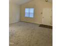 Bright and airy living room featuring neutral carpet, vaulted ceiling, and a large window with blinds for natural light at 309 Gladstone Dr, Durham, NC 27703