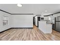 Open-concept living space with hardwood floors that seamlessly flows into the modern kitchen at 409 S 13Th St, Lillington, NC 27546