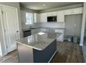 Modern kitchen featuring granite countertops, a kitchen island, and white cabinets at 42 Heatherglenn Cir, Princeton, NC 27569