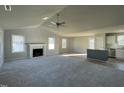 Bright and airy living room with a fireplace and ceiling fan, adjacent to the modern kitchen at 42 Heatherglenn Cir, Princeton, NC 27569