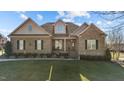 Charming brick home with manicured lawn, covered porch, and inviting curb appeal on a sunny day at 4278 Aviemore, Burlington, NC 27215