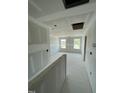 Hallway of unfinished home showing two large windows and a view to another room at 432 E Clydes Point Way, Wendell, NC 27591