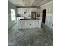 Spacious kitchen with white cabinets and a central island under construction at 432 E Clydes Point Way, Wendell, NC 27591