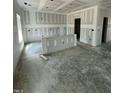 Spacious unfinished living room with drywall and ample natural light ready for customization at 432 E Clydes Point Way, Wendell, NC 27591