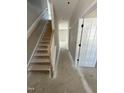 A staircase with wooden handrail leads to the upper level of this house at 432 E Clydes Point Way, Wendell, NC 27591