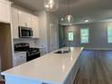 Open kitchen featuring stainless steel appliances, an island, and a view of the open floor plan at 500 Yeowell Dr, Chapel Hill, NC 27514