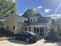 Exterior view showcasing a screened porch and convenient car parking at 531 N Main St, Graham, NC 27253