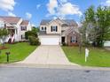 Inviting two-story home with a well-kept lawn, long driveway, and traditional architecture at 6013 Shelane Ct, Raleigh, NC 27610