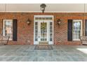Inviting front porch features a decorative door, sconces, and a swing for relaxing at 6709 Windchase Dr, Rocky Mount, NC 27803
