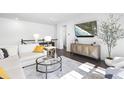 Bright living room with a comfortable sofa, modern decor, and a mounted TV for entertainment at 8401 Zinc Autumn Path Path, Raleigh, NC 27615