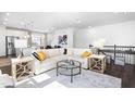 Stylish open-concept living room with a plush sofa, glass coffee table, and contemporary design elements at 8401 Zinc Autumn Path Path, Raleigh, NC 27615